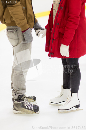 Image of close up of happy couple skating on ice rink