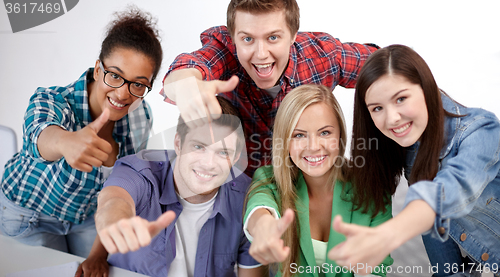 Image of group of happy students showing thumbs up
