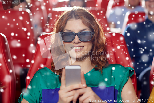 Image of happy woman with smartphone in 3d movie theater