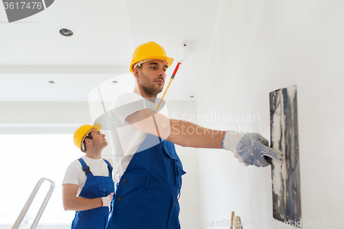 Image of group of builders with tools indoors