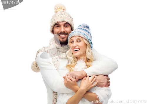 Image of smiling couple in winter clothes hugging