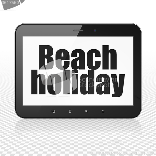 Image of Tourism concept: Tablet Computer with Beach Holiday on display