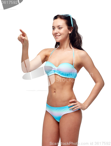 Image of happy woman in bikini swimsuit pointing finger