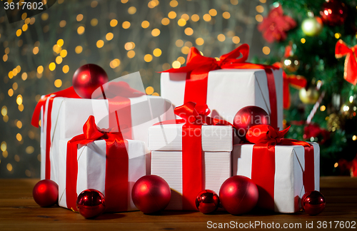 Image of gift boxes and red balls under christmas tree