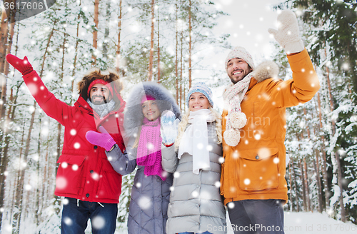 Image of group of friends waving hands in winter forest