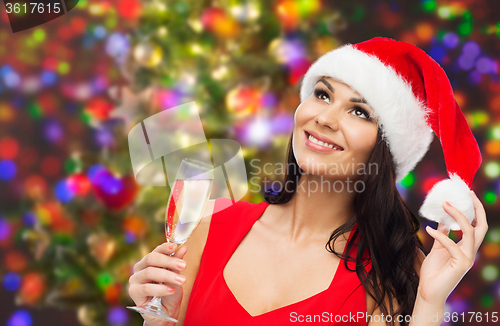 Image of beautiful woman in santa hat with champagne glass