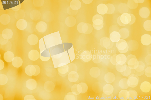 Image of blurred golden background with bokeh lights