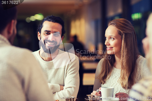 Image of happy friends meeting and drinking tea or coffee