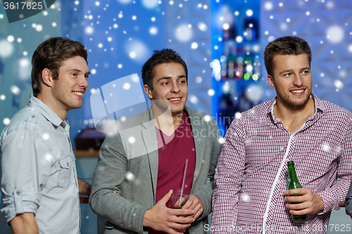 Image of group of male friends with beer in nightclub