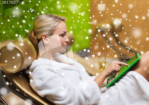 Image of beautiful young woman with  tablet pc at spa