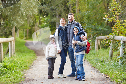 Image of happy family with backpacks hiking