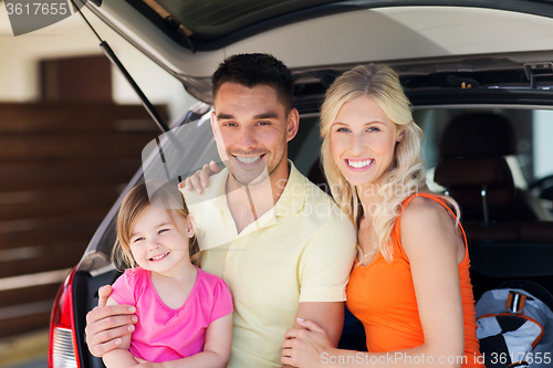 Image of happy family with hatchback car at home parking