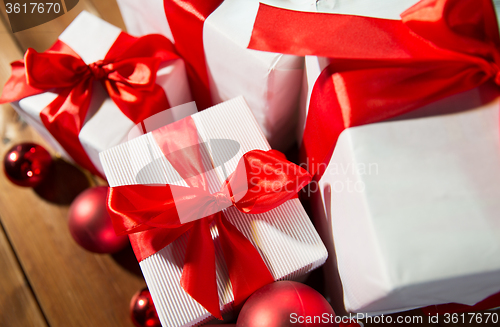 Image of close up of gift boxes and red christmas balls