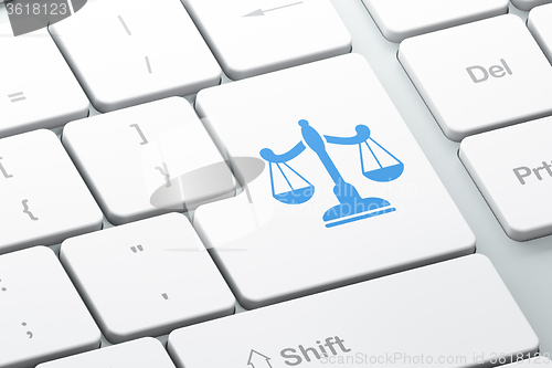 Image of Law concept: Scales on computer keyboard background