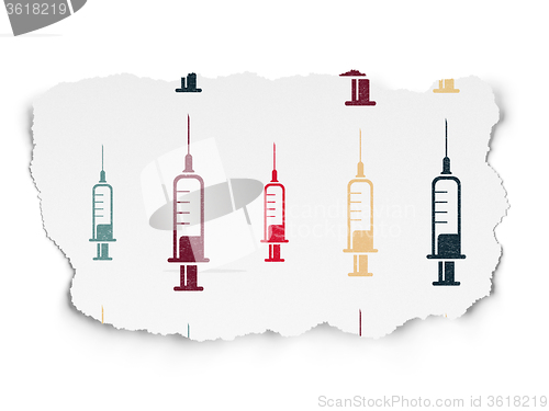 Image of Medicine concept: Syringe icons on Torn Paper background