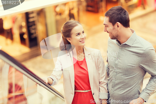 Image of happy young couple with shopping bags in mall