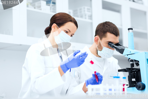 Image of young scientists making test or research in lab