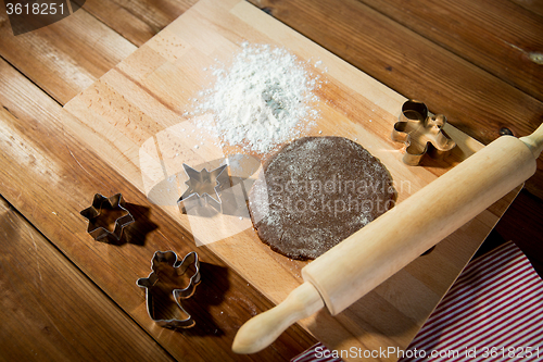 Image of close up of ginger dough, molds and rolling pin