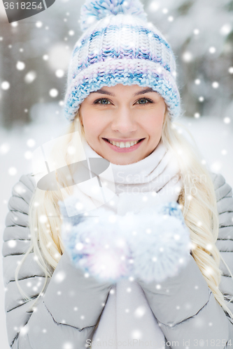 Image of smiling young woman in winter forest