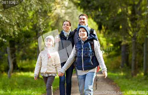 Image of happy family with backpacks hiking