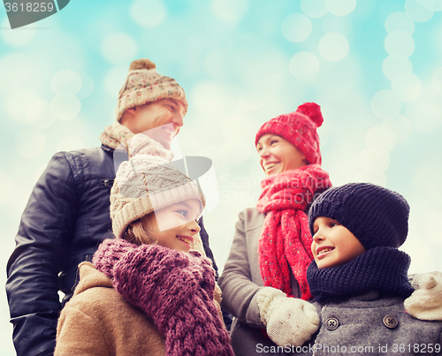 Image of happy family in winter clothes outdoors