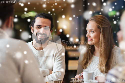 Image of happy friends meeting and drinking tea or coffee