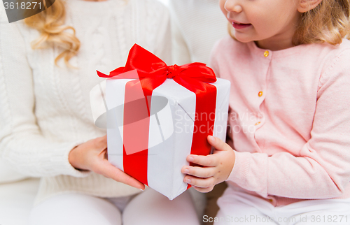 Image of close up of mother and little girl with gift box