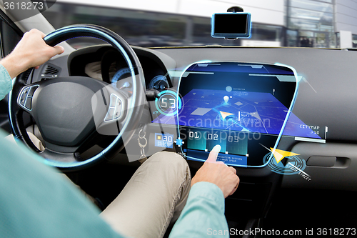 Image of close up of man driving car with navigation system