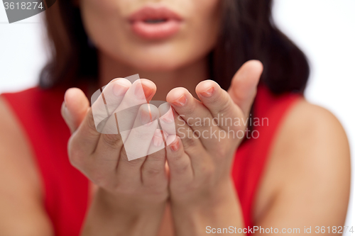 Image of close up of woman hands sending blow kiss