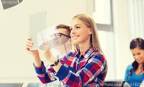 Image of group of smiling students with tablet pc