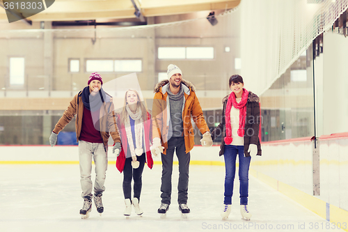 Image of happy friends on skating rink