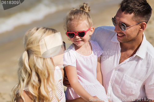 Image of happy family in sunglasses on summer beach