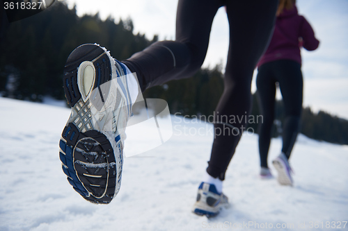 Image of couple jogging outside on snow