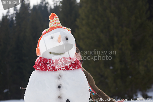 Image of couple having fun and walking in snow shoes