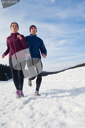 Image of couple jogging outside on snow