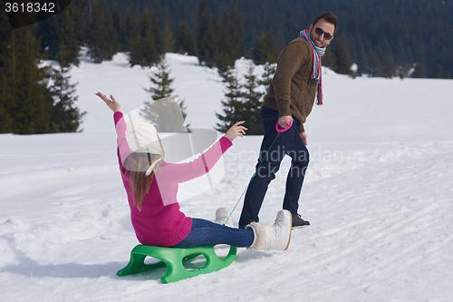 Image of happy young couple having fun on fresh show on winter vacation