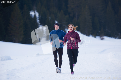 Image of couple jogging outside on snow