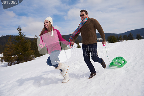 Image of happy young couple having fun on fresh show on winter vacation