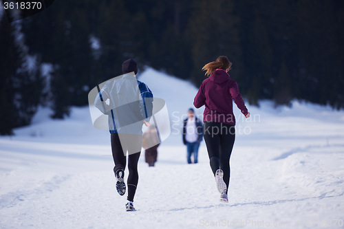 Image of couple jogging outside on snow