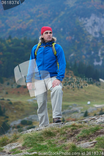 Image of advanture man with backpack hiking