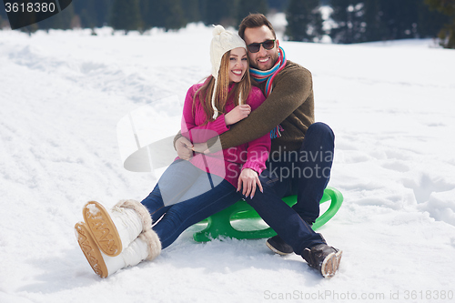 Image of happy young couple having fun on fresh show on winter vacation