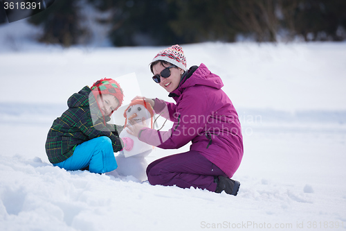 Image of happy family building snowman