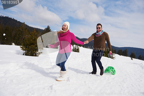 Image of happy young couple having fun on fresh show on winter vacation