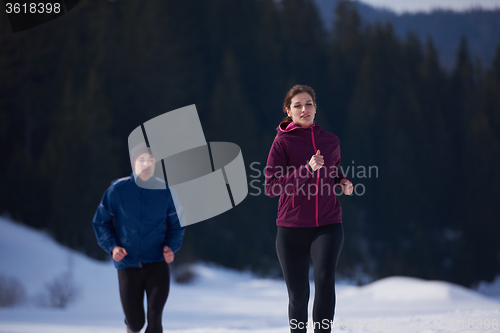 Image of couple jogging outside on snow