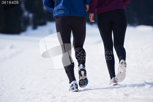 Image of couple jogging outside on snow