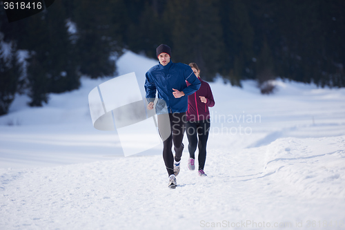 Image of couple jogging outside on snow