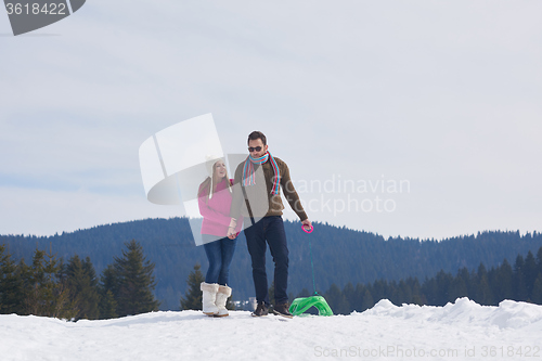 Image of happy young couple having fun on fresh show on winter vacation