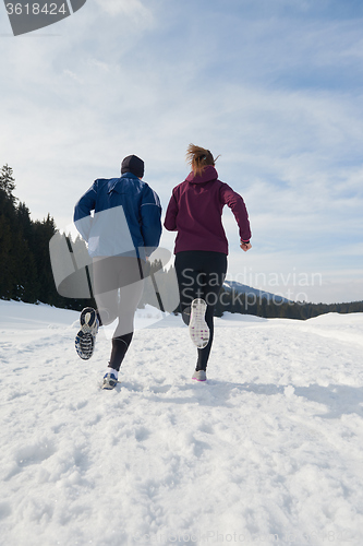 Image of couple jogging outside on snow