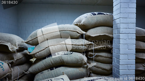 Image of stack of burlap sacks with coffee beans