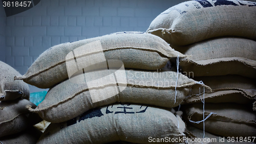 Image of stack of burlap sacks with coffee beans